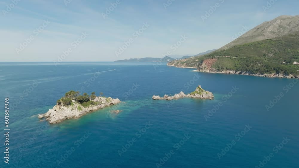Aerial view travel destination Sveta Nedjelja Island in Petrovac, Montenegro. Blue sea around the islands in sea. Aerial view travel destination Sveta Nedjelja Island in Petrovac, Montenegro. Blue sea around the islands in sea.