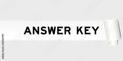 Ripped gray paper background that have word answer key under torn part