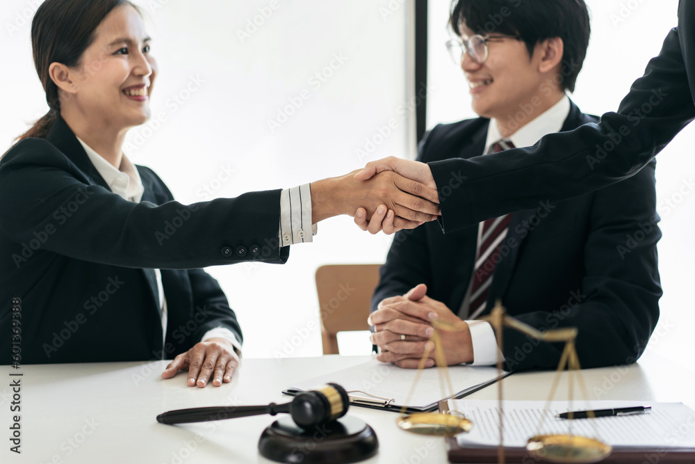 Female lawyer shaking hands with client after discussing deal of Female lawyer shaking hands with client after discussing deal of