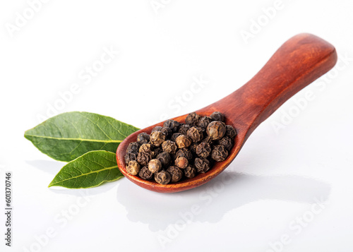 Black pepper and bay leaves isolated on a white background. View from above.