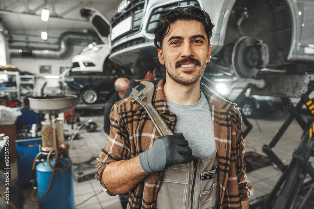 Portrait of a male mechanic in an auto repair shop Portrait of a male mechanic in an auto repair shop