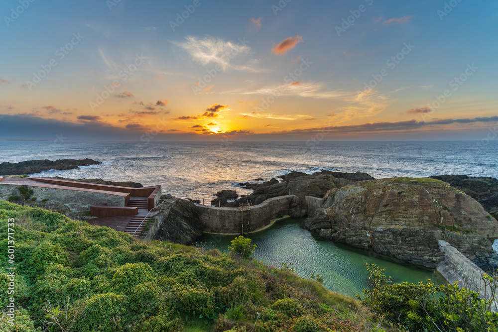 Natural pools at sunset in the tourist village of Tapia de Casariego, in Asturias, Spain.