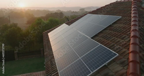 Wallpaper Mural Aerial view of sunlight catching the photovoltaic solar panels on a suburban house rooftop. Climate change,Global warming Torontodigital.ca