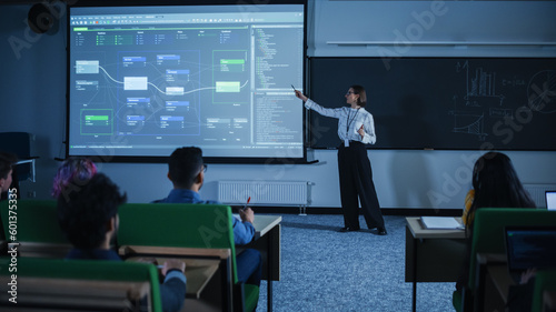 Obraz na plátne Young Female Teacher Giving a Data Science Lecture to Diverse Multiethnic Group of Female and Male Students in Dark College Room