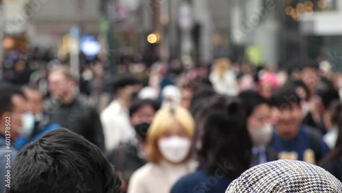 Wallpaper Mural SHIBUYA, TOKYO, JAPAN - APRIL 2023 : Back shot and crowd of people at SHIBUYA SCRAMBLE CROSSING. Japanese people, urban city life, travel and tourism concept video in 4K. Shot in daytime. Torontodigital.ca