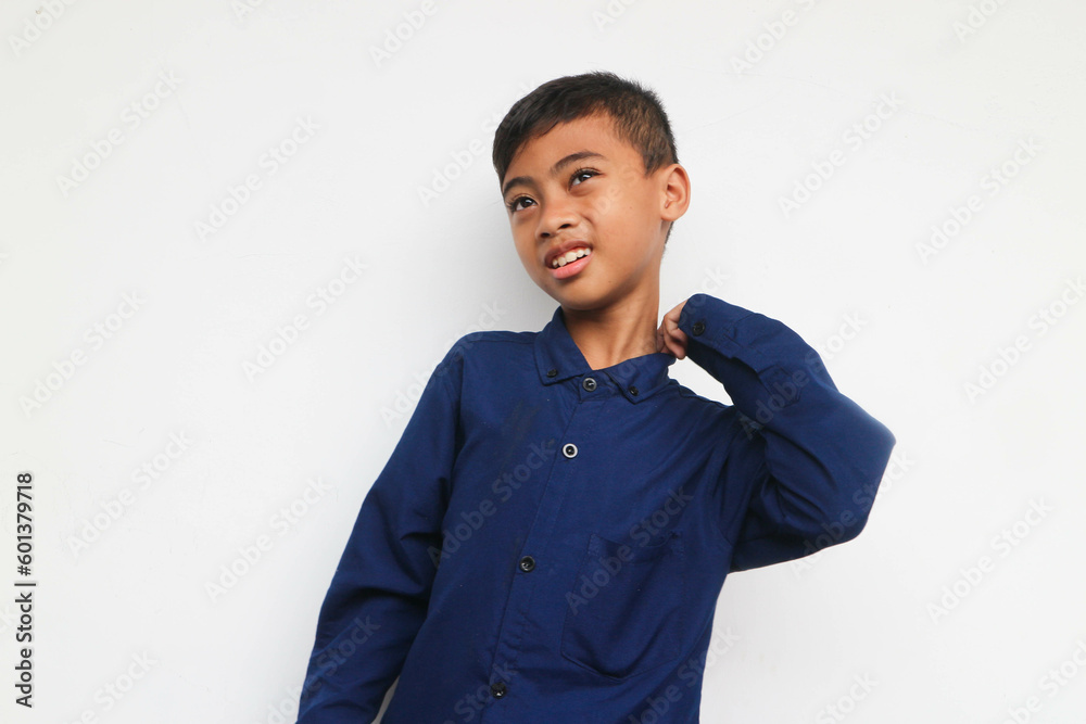 Cute bewildered boy in blue shirt looking at camera with smile isolated on the white background Cute bewildered boy in blue shirt looking at camera with smile isolated on the white background