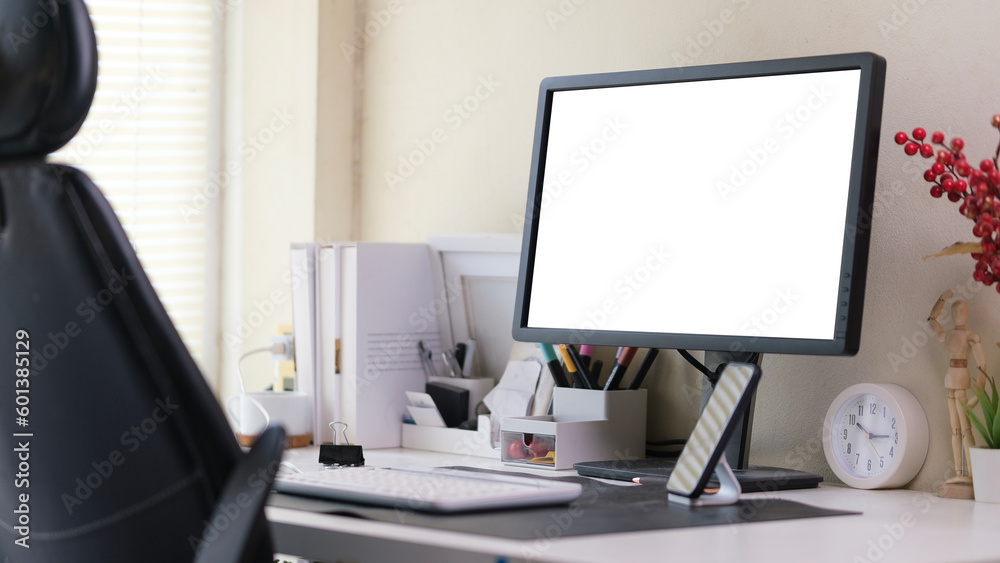 Home office interior with blank computer monitor and office supplies on white table. Home office interior with blank computer monitor and office supplies on white table.