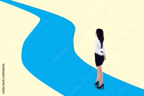 Businesswoman standing on winding path