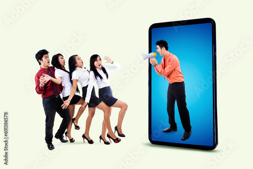 Angry boss on a cellphone screen shouting with a megaphone