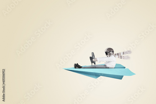 Young boy riding paper plane