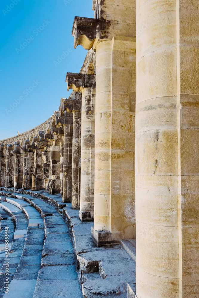 Photo of the intricately carved columns on the upper balcony of Aspendos ancient theater, showcasing the architectural mastery and beauty of the historic site.