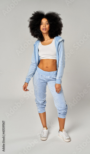 Beautiful african american girl with an afro hairstyle wear blue velour tracksuit