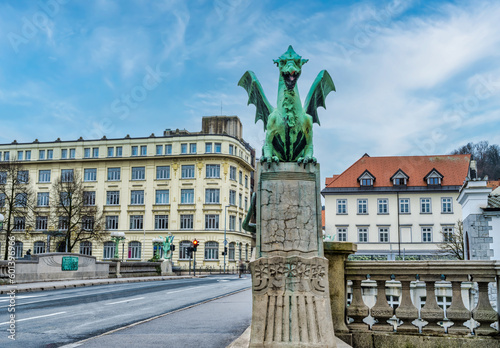 Zmajski most, Dragon Bridge and baroque Baroque building in the background, Ljubljana, Slovenia photo