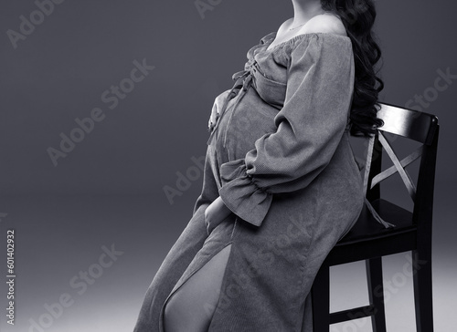 pregnant woman is sitting on a chair