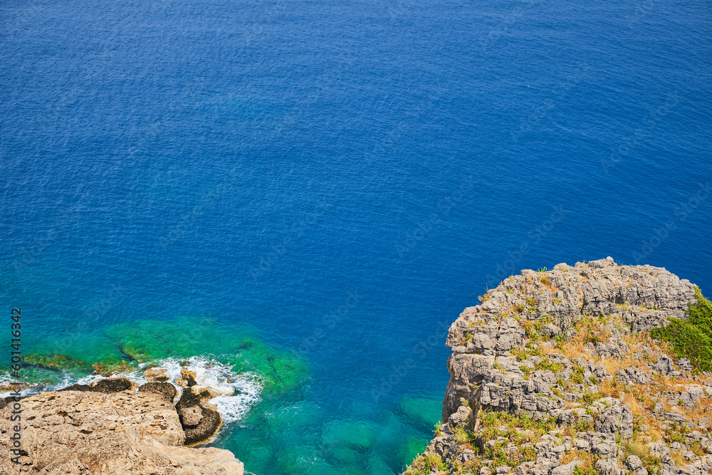 View from the acropolis of Lindos to the clear blue sky and emerald sea on island of Rhodes, famous place for holidays and travel around the islands of the Greek islands of the Dodecanese archipelago