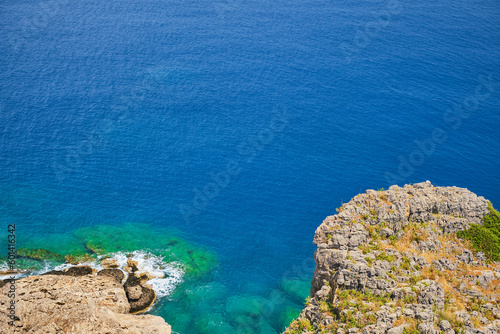 View from the acropolis of Lindos to the clear blue sky and emerald sea on island of Rhodes, famous place for holidays and travel around the islands of the Greek islands of the Dodecanese archipelago