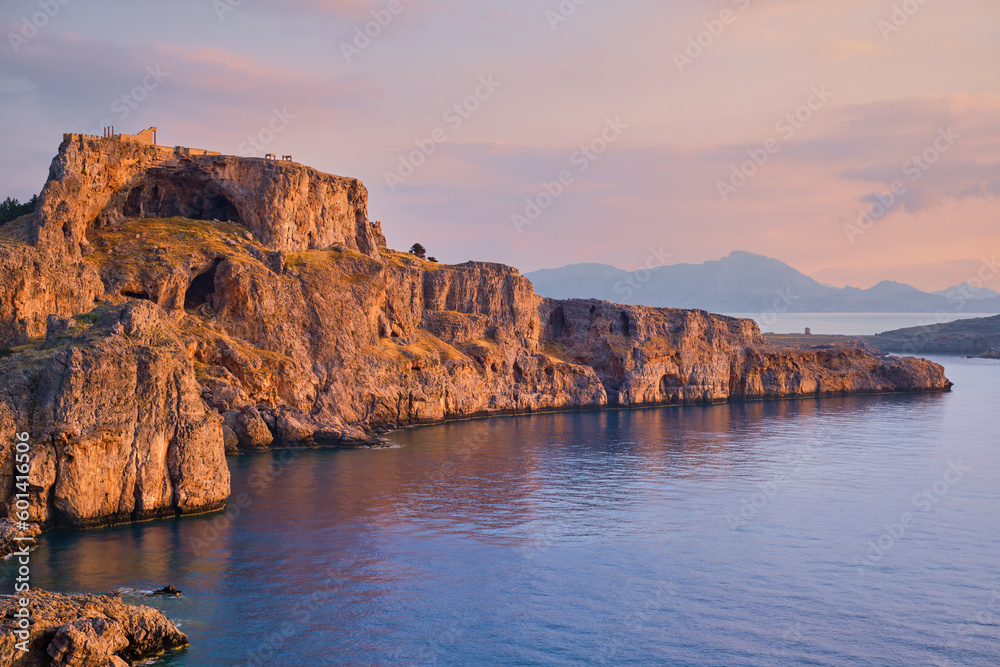 Beautiful view of the Acropolis of Lindos, rocks and beautiful sea lit by the early morning sun, Rhodes Island is a well-known holiday and travel destination in the Greek islands