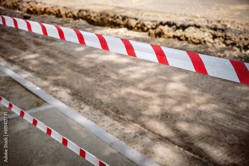 Close-up barrage tape for fencing during construction or repair roads in the city. © SKfoto
