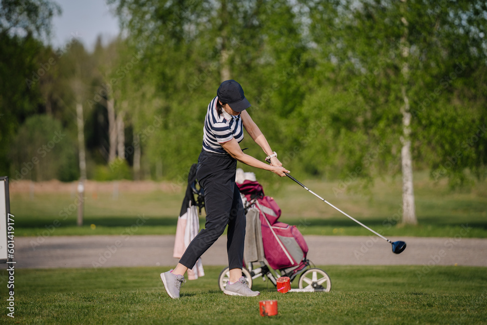Obraz premium Golfer sport course golf ball fairway. People lifestyle woman playing game golf and hitting go on green grass. Female player game shot in summer. Healthy and Sport outdoor