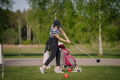 Golfer sport course golf ball fairway. People lifestyle woman playing game golf and hitting go on green grass. Female player game shot in summer. Healthy and Sport outdoor