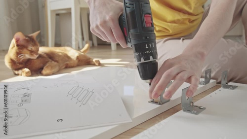 Wallpaper Mural Young woman holding electric drill tool to assemble furniture in new home Torontodigital.ca