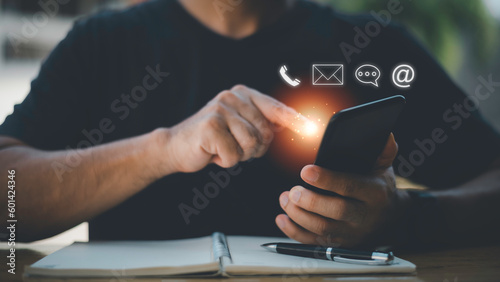 Businessman using Smart Phone with the email, call phone, address, Chat message icons.Customer support hotline Contact us people connection. photo