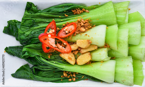 Canvastavla Vietnamese stir fried cabbage with garlic isolated on black background for a men