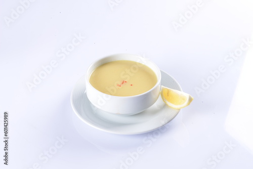 Lentil Soup with lemon and hot oil sauce, in white bowl