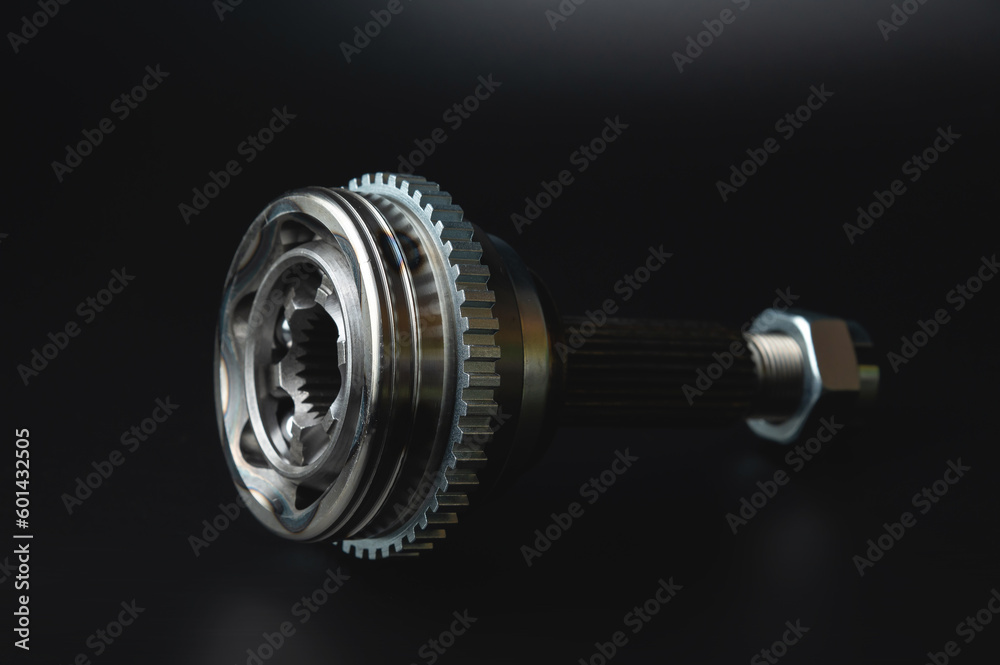 Auto CV joint Connecting the drive shaft on a black background. New hinges of equal angular speeds. New car CV joints. Quality spare parts for car service or repair Auto CV joint Connecting the drive shaft on a black background. New hinges of equal angular speeds. New car CV joints. Quality spare parts for car service or repair