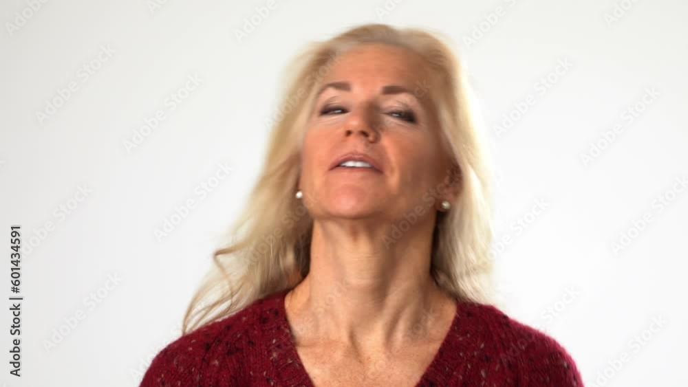 Closeup of fun elderly blonde woman lady 50s years old wear red sweater do phone gesture call me back isolated on solid white background studio portrait