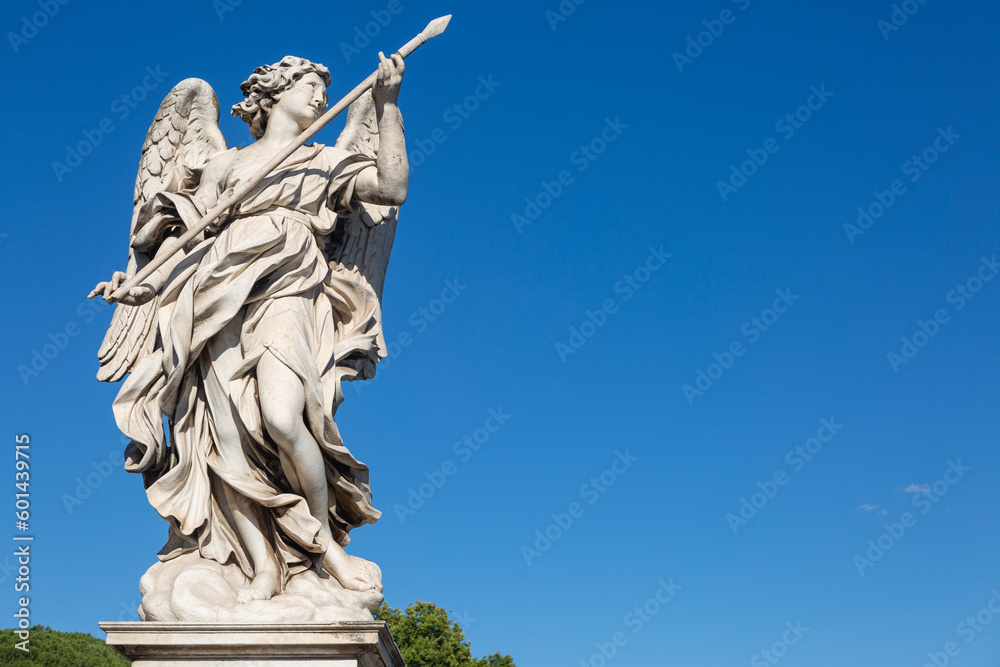 An ancient statue of an angel with with a spear in Rome, Italy