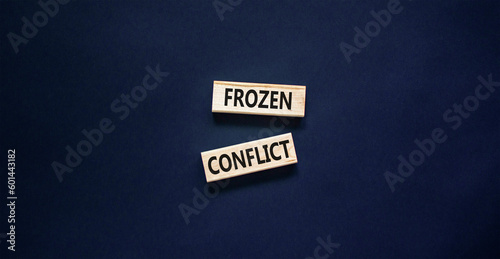 Frozen conflict symbol. Concept words Frozen conflict on beautiful wooden block. Beautiful black table black background. Business and Frozen conflict concept. Copy space.