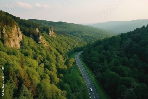  road trip by car, van, or RV journeys along an asphalt freeway, green trees road, drone view photo