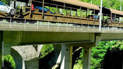 car transport vehicles driving along Lötschberg railway tunnel, old train with cars and passengers, transportation transport in Switzerland from Kandersteg to Goppenstein, concept travel in mountains photo