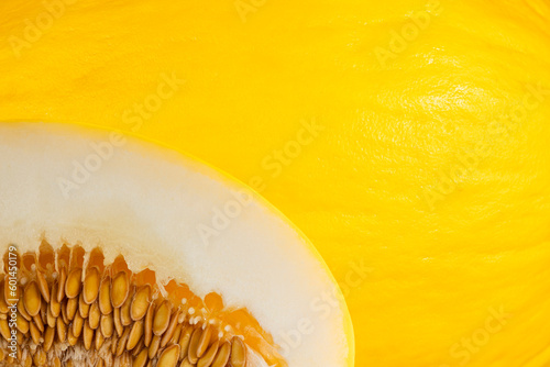 melon pulp with seeds on a yellow melon peel background