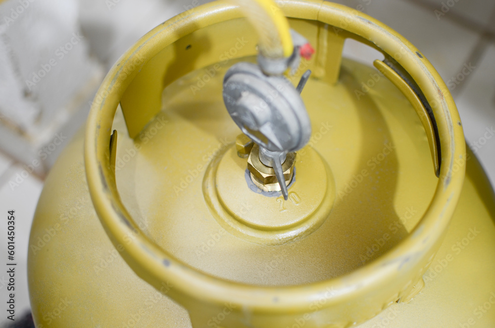 Cooking gas. Photo of a kitchen gas cylinder connected to a gas