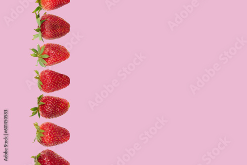composition whith strawberries on a pink background