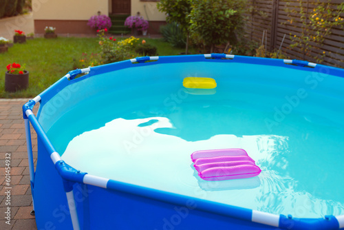 Two inflatable pillows lie on the surface of the water in the pool