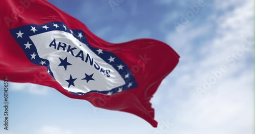 Seamless loop in slow motion of Arkansas state flag waving on a clear day photo