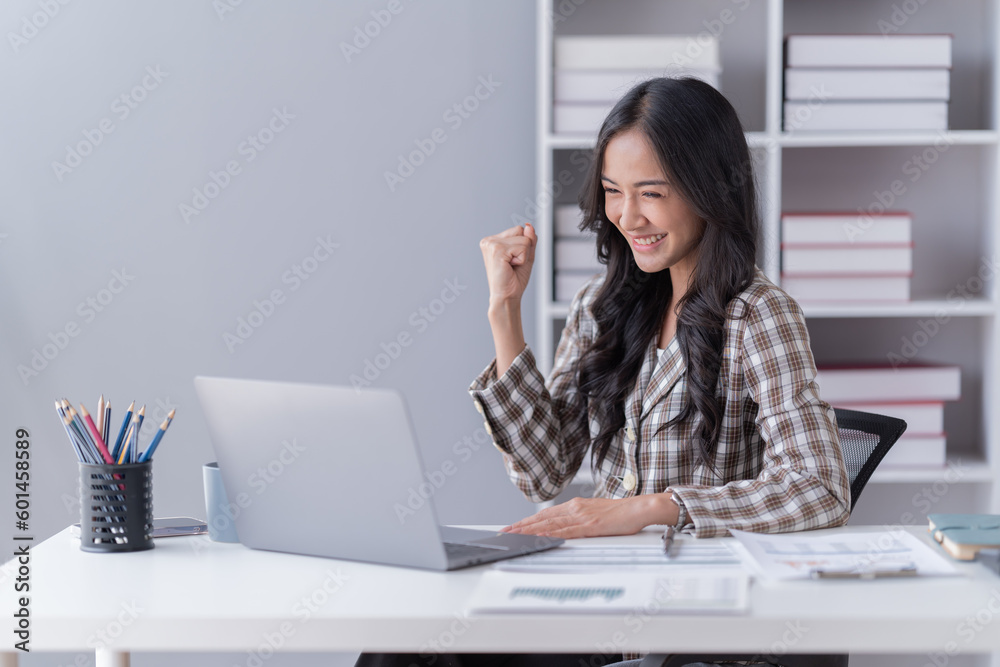 young asian businesswoman working on laptop computer in her workstation. Portrait of Businesspeople employee freelance online marketing e-commerce telemarketing concept. young asian businesswoman working on laptop computer in her workstation. Portrait of Businesspeople employee freelance online marketing e-commerce telemarketing concept.