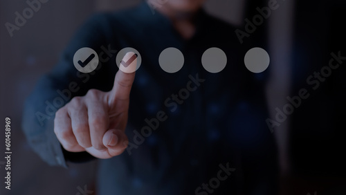 Businessman touching tick icon on virtual screen. Checklist concept