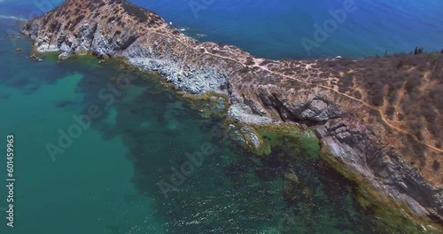 Strafe Aerial Over Deserted Island with Dirt Trail Leading to Ocean