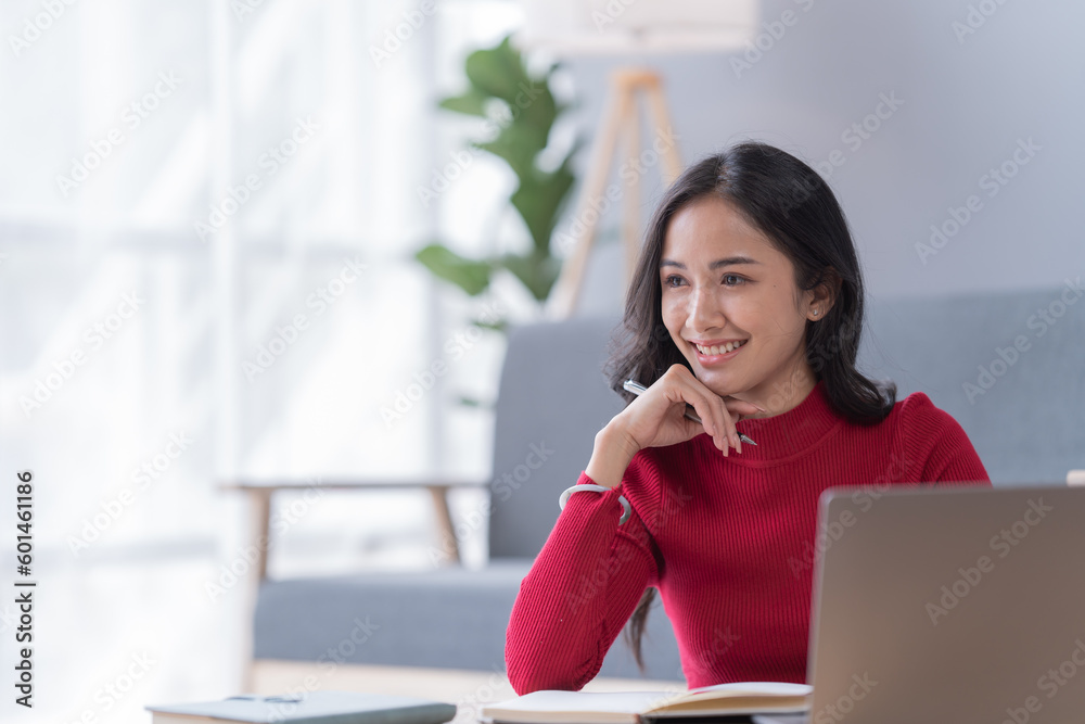 Smile of beautiful woman with earphone and smartphone siting on sofa at home Smile of beautiful woman with earphone and smartphone siting on sofa at home