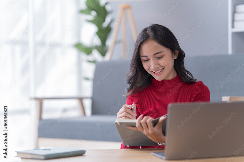Smile of beautiful woman with earphone and smartphone siting on sofa at home Smile of beautiful woman with earphone and smartphone siting on sofa at home