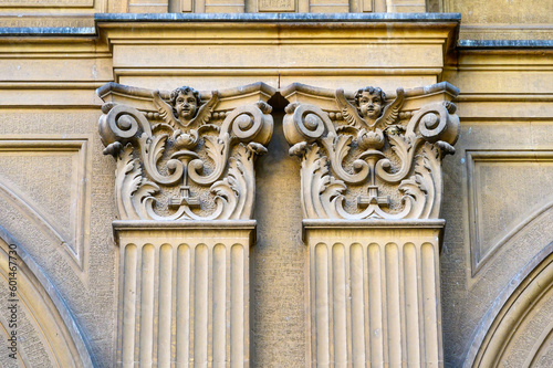 Capital decorations in an old column in Valencia, Spain