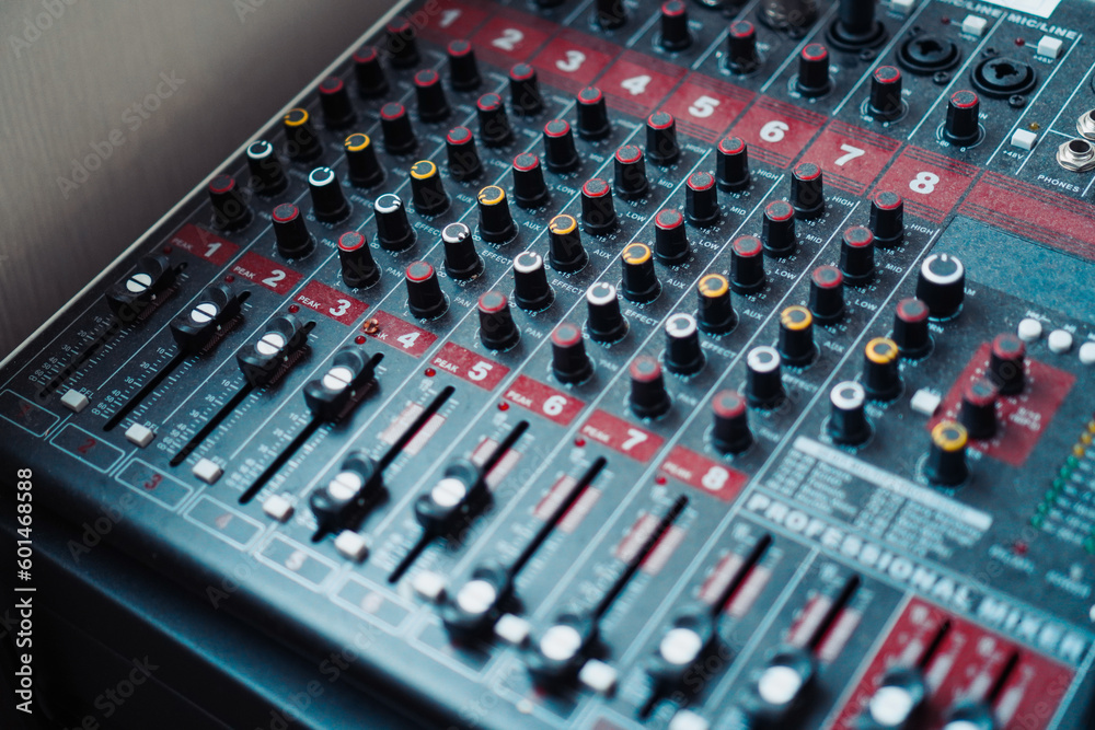 Detailed view of sound mixer featuring an array of buttons and sliders for audio customization