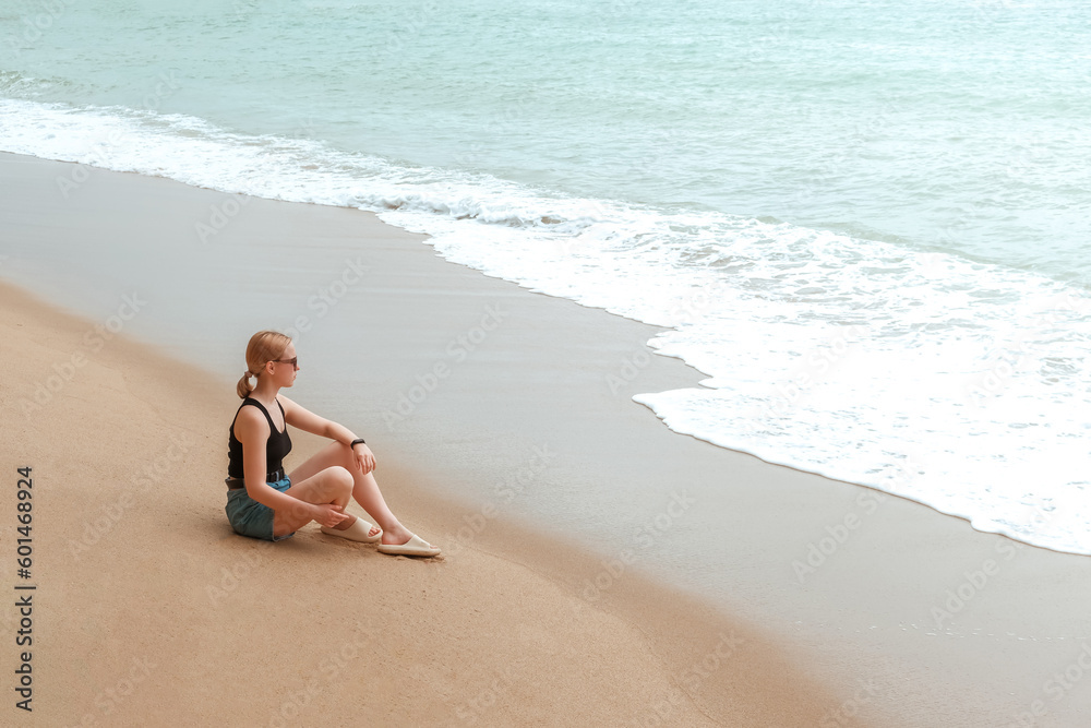 Travel. Travelers woman on the coast of the ocean on a tropical island. Solitude, wildlife, mental health, conscious travel, travel and active life concept. Travel banner Travel. Travelers woman on the coast of the ocean on a tropical island. Solitude, wildlife, mental health, conscious travel, travel and active life concept. Travel banner