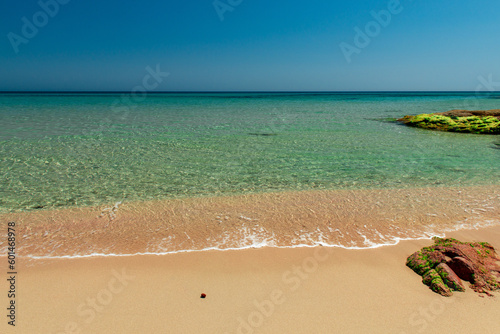 Beautiful Mediterranean view view of sunny beach with blue sky and turquoise sea. Holiday destination Santa Margherita di Pula, Sardinia, Italy.