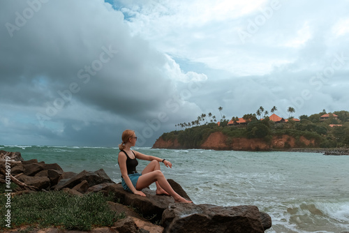 Travel. Travelers woman on the coast of the ocean on a tropical island. Solitude, wildlife, mental health, conscious travel, travel and active life concept. Travel banner photo