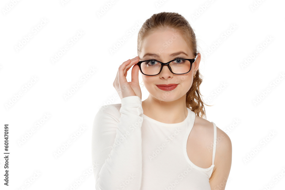 Portrait of smiling young blonde woman wearing glasses on a white background